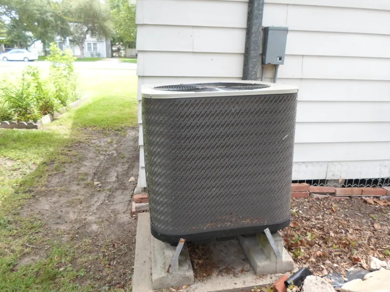 An outdoor AC condenser unit checked during an inspection