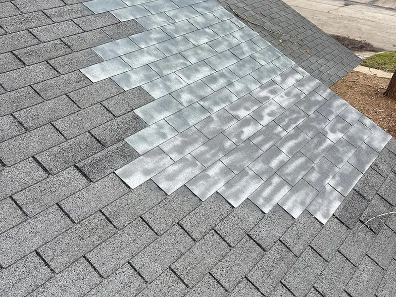 Fresh shingles being laid on a new roof