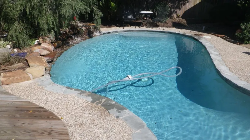 A backyard pool with an automatic pool cleaner, checked during an inspection